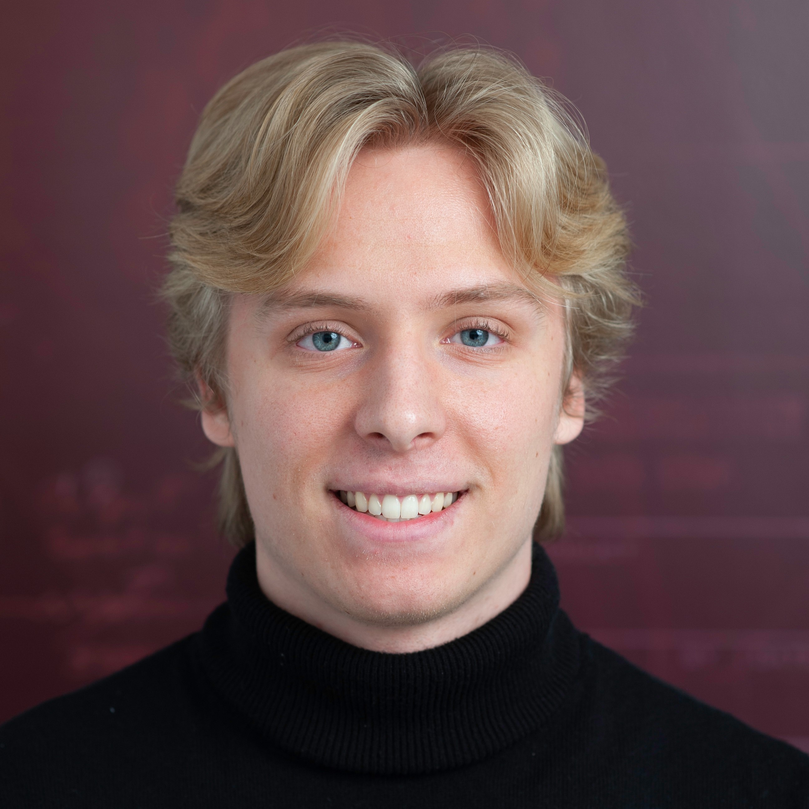 A professional headshot of Clayton Carlson.